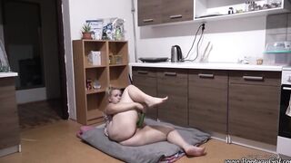 Phat butt women masturbates with cucumber inside kitchen.