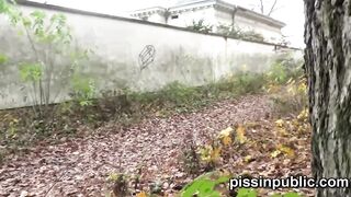 Daring girls pissing on the frequented pathway and are meeting by passers-by