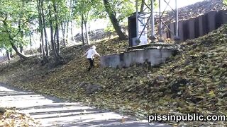 Daring girls pissing on the frequented pathway and are meeting by passers-by