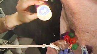 Dominas ropes guy's collared face and pulls his tied penis
