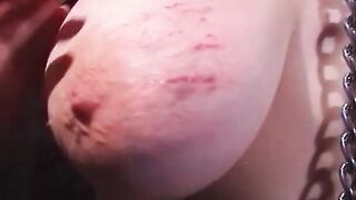 Huge-tits shackled sub gets her boobies scratched