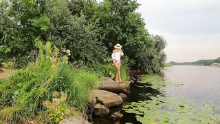 Wonderful blonde woman go swim inside dress. Outdoors nude.