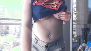 Supergirl Dressed flashing melons inside balcony