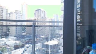 Supergirl Dressed flashing melons inside balcony
