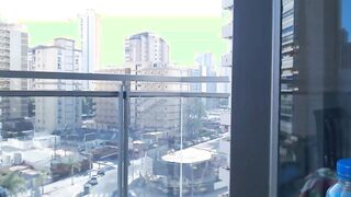 Supergirl Dressed flashing melons inside balcony