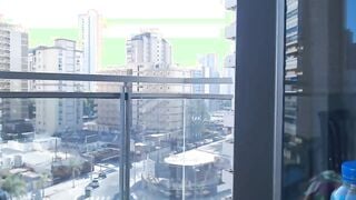 Supergirl Dressed flashing melons inside balcony