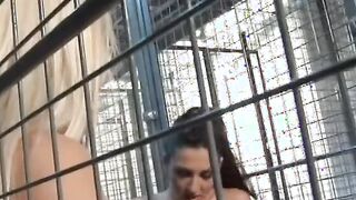 Lesbians licking each other's twats inside cage