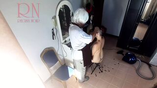 Camera inside naked barbershop. Hairdresser makes undress lady ho cut her hair. Barber, nudism. WEBCAM two