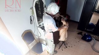 Camera inside naked barbershop. Hairdresser makes undress lady ho cut her hair. Barber, nudism. WEBCAM two