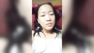 chinese women alone solo bored to be at home alone having fun with fruit