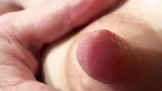 Female breast milk and nipple close up