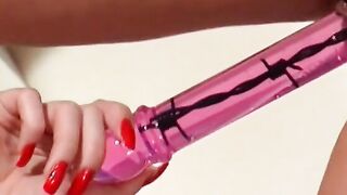 beauty platinum blonde stands over dark haired for dark hair to slide sex toy up her twat