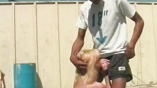 Blonde whore blows and fucks big ebony penis on a rooftop