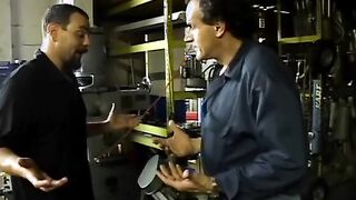 2 service technicians drill stunning dark hair inside the garage