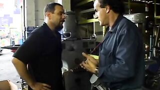 2 service technicians drill stunning dark hair inside the garage