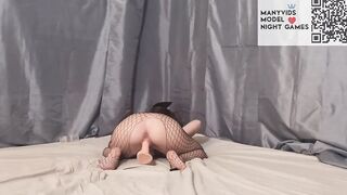 bimbos into a mask and a mesh on the body blows and fucks a toy