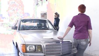 Fixing up a red haired dyke women into a vehicle service by a blondie handywoman