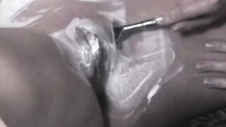 Vulgar dark haired sex fiend uses a leather whip on her round booty