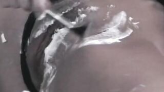 Vulgar dark haired sex fiend uses a leather whip on her round booty
