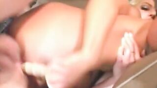 Huge breasted blonde blows a sex toy then takes it up her butt while getting screwed