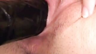 Sensual dark haired spreads her vagina wide and slides a long sex toy into it
