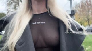A women shows her tits while walking inside outdoor into the city