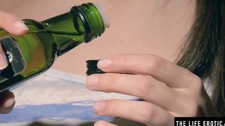 Using oil for lube as she puts her finger inside her tight holes