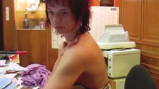 Lusty German red head masturbating inside the office