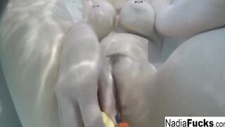 Bombshell Nadia takes a hot tub with some latex duckies