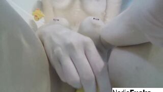Bombshell Nadia takes a hot tub with some latex duckies