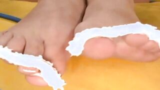 Blonde bimbo with nice jugs getting a cumshot on her goddess foot after the fuck