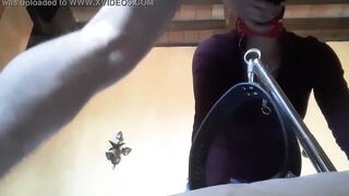 Bound to a machine, masked and hooded, she has to suck a long penis