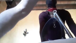 Bound to a machine, masked and hooded, she has to suck a long penis