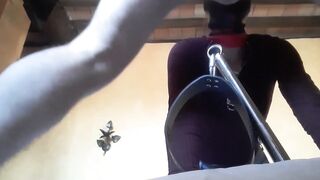 Bound to a machine, masked and hooded, she has to suck a long penis