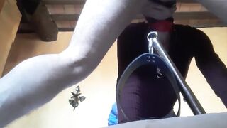 Bound to a machine, masked and hooded, she has to suck a long penis