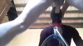 Bound to a machine, masked and hooded, she has to suck a long penis