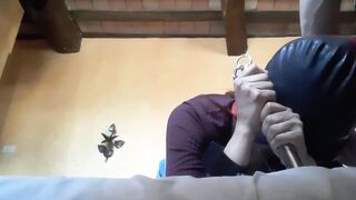 Bound to a machine, masked and hooded, she has to suck a long penis