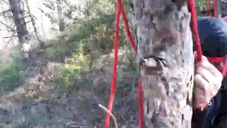Bound to a tree on a beauty outfit, masked and outdoors deep throat with no mercy