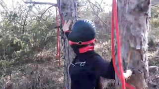 Bound to a tree on a beauty outfit, masked and outdoors deep throat with no mercy