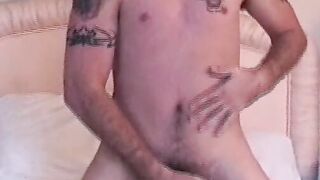 Muscular youngster shows tattoos before wanking off