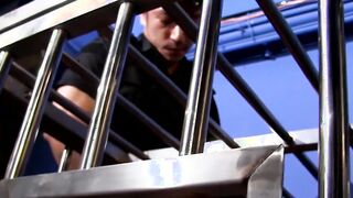 Young man in cage enjoys having large cock up his ass