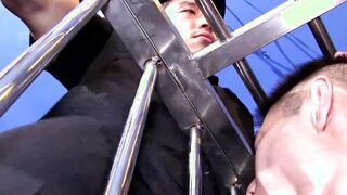 Young man in cage enjoys having large cock up his ass
