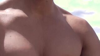 Oriental jock with a pretty face strokes his dick outdoors
