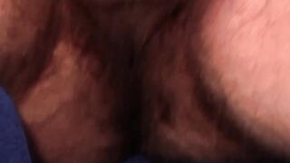 Hairy gay with shaved balls strokes cock while watching porn