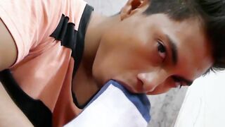 Asian twink sniffs his boots and feet before jerking off