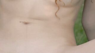 Young redhead sensually teasing in nature