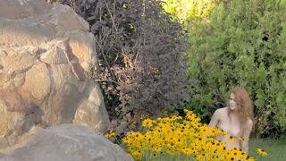 Young redhead sensually teasing in nature