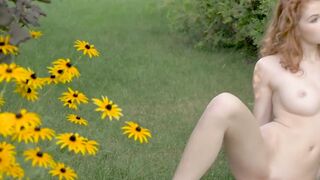 Young redhead sensually teasing in nature