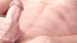 Hung guy tugs his hard hairy dick until spraying a big load
