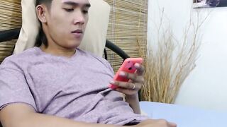 Little Oriental twink sniffs his feet and jerks off